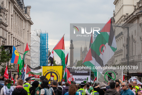 Pro-Palestinian activists and supporters wave Palestinian flags and hold placards as they march through London, United Kingdom, on September...