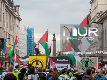 Pro-Palestinian activists and supporters wave Palestinian flags and hold placards as they march through London, United Kingdom, on September...