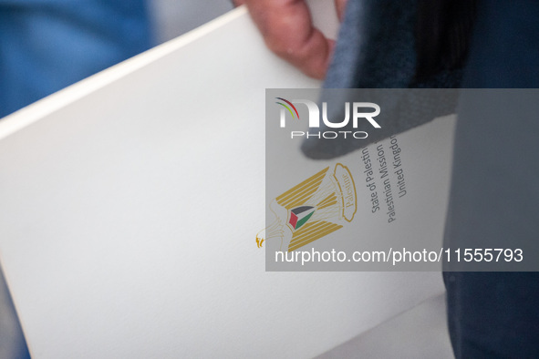 A member of the Palestinian Mission to the UK holds an official document during a Pro-Palestinian march through London, United Kingdom, on S...