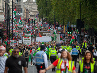 Pro-Palestinian activists and supporters wave Palestinian flags and hold placards as they march through London, United Kingdom, on September...