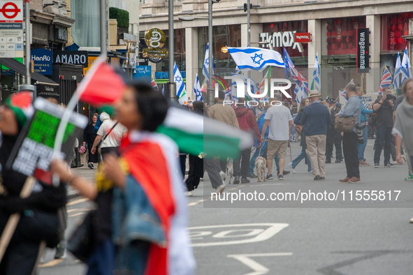 Pro-Palestinian and pro-Israel protesters wave flags during a march through London, United Kingdom, on September 7, 2024. Demonstrators from...