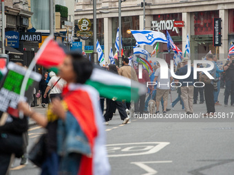 Pro-Palestinian and pro-Israel protesters wave flags during a march through London, United Kingdom, on September 7, 2024. Demonstrators from...