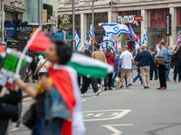 Pro-Palestinian and pro-Israel protesters wave flags during a march through London, United Kingdom, on September 7, 2024. Demonstrators from...