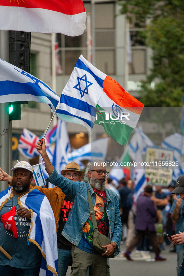 A pro-Israel protester holds a joint Israel-India flag during a counter-protest to the pro-Palestinian National Day of Action for Palestine...