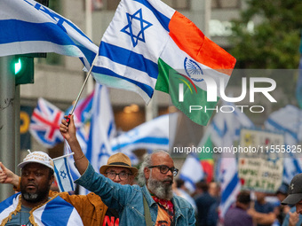 A pro-Israel protester holds a joint Israel-India flag during a counter-protest to the pro-Palestinian National Day of Action for Palestine...