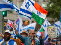 A pro-Israel protester holds a joint Israel-India flag during a counter-protest to the pro-Palestinian National Day of Action for Palestine...