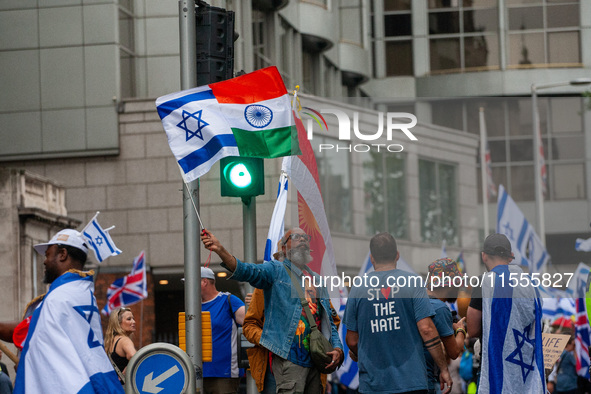 A pro-Israel protester holds a joint Israel-India flag during a counter-protest to the pro-Palestinian National Day of Action for Palestine...