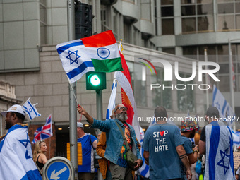 A pro-Israel protester holds a joint Israel-India flag during a counter-protest to the pro-Palestinian National Day of Action for Palestine...