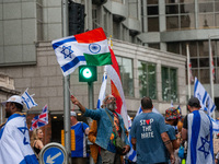 A pro-Israel protester holds a joint Israel-India flag during a counter-protest to the pro-Palestinian National Day of Action for Palestine...