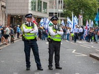 Metropolitan Police officers in London, United Kingdom, stand in front of pro-Israel protesters during the pro-Palestinian National Day of A...