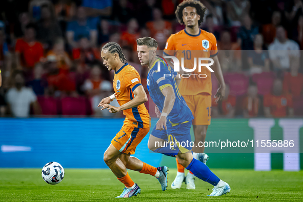 Netherlands midfielder Xavi Simons and Bosnia and Herzegovina forward Ermedin Demirovic during the match between the Netherlands and Bosnia...