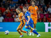 Netherlands midfielder Xavi Simons and Bosnia and Herzegovina forward Ermedin Demirovic during the match between the Netherlands and Bosnia...