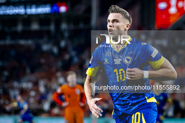 Bosnia and Herzegovina forward Ermedin Demirovic scores the 1-1 and celebrates the goal during the match between the Netherlands and Bosnia...