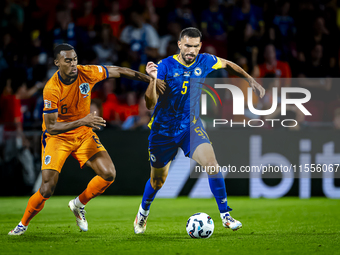 Netherlands midfielder Ryan Gravenberch and Bosnia and Herzegovina defender Adrian Leon Barisic during the match between the Netherlands and...