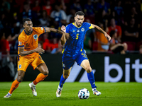 Netherlands midfielder Ryan Gravenberch and Bosnia and Herzegovina defender Adrian Leon Barisic during the match between the Netherlands and...