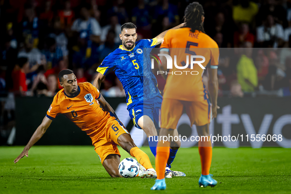 Netherlands midfielder Ryan Gravenberch and Bosnia and Herzegovina defender Adrian Leon Barisic during the match between the Netherlands and...