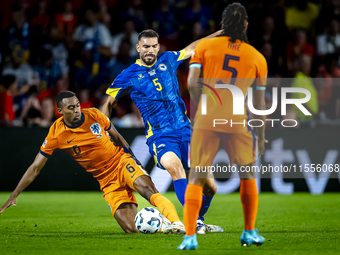 Netherlands midfielder Ryan Gravenberch and Bosnia and Herzegovina defender Adrian Leon Barisic during the match between the Netherlands and...