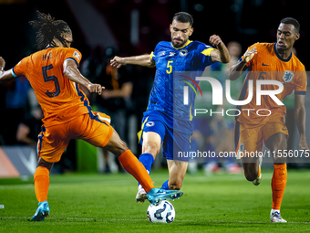 Netherlands midfielder Ryan Gravenberch and Bosnia and Herzegovina defender Adrian Leon Barisic during the match between the Netherlands and...