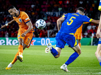 Netherlands forward Cody Gakpo and Bosnia and Herzegovina defender Adrian Leon Barisic during the match between the Netherlands and Bosnia a...