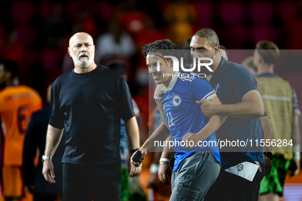 A supporter of Bosnia and Herzegovina stands on the pitch during the match between the Netherlands and Bosnia and Herzegovina at the Philips...