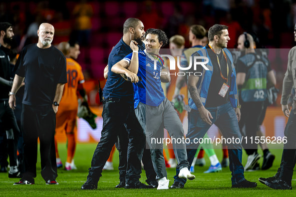 A supporter of Bosnia and Herzegovina stands on the pitch during the match between the Netherlands and Bosnia and Herzegovina at the Philips...