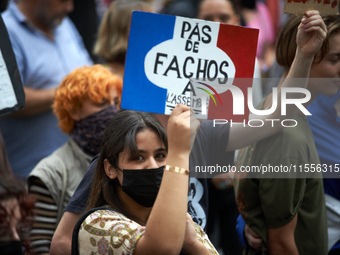 A young woman holds a cardboard sign reading 'No faf in our National Assembly'. Between 5,000 and 8,000 protesters march in Toulouse, France...