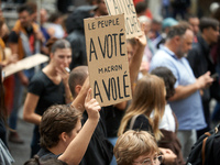 A placard reads 'People have voted, Macron stole it'. Between 5,000 and 8,000 protesters march in Toulouse and cities across France on Satur...