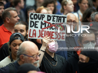 A protester holds a placard reading 'Coup d'etat of the youth'. Between 5,000 and 8,000 protesters march in Toulouse and cities across Franc...