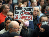 A protester holds a placard reading 'Coup d'etat of the youth'. Between 5,000 and 8,000 protesters march in Toulouse and cities across Franc...