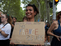 A young woman holds a placard reading 'My France weeps'. Between 5,000 and 8,000 protesters march in Toulouse and cities across France on Sa...