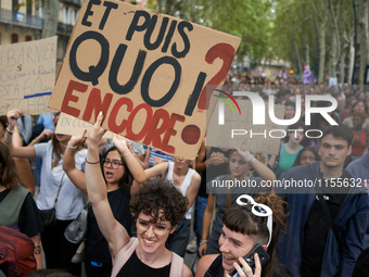 A protester holds a placard reading 'And now, what else?'. Between 5,000 and 8,000 protesters march in Toulouse, France, on September 7, 202...