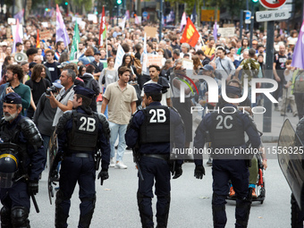 Riot policemen face the protesters. Between 5,000 and 8,000 protesters march in Toulouse, France, on September 7, 2024, to protest against M...