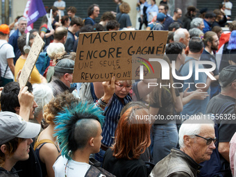 A man holds a cardboard sign reading 'Macron won again, only solution: revolution'. Between 5,000 and 8,000 protesters march in Toulouse, Fr...