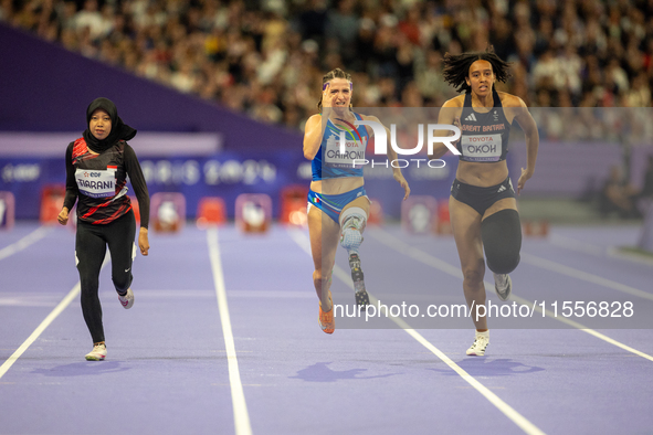 Karisma Tiarani of Indonesia, Martina Caironi of Italy, and Okoh Ndidikama of the UK compete in the Women's 100m - T63 Final at Stade de Fra...