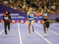 Karisma Tiarani of Indonesia, Martina Caironi of Italy, and Okoh Ndidikama of the UK compete in the Women's 100m - T63 Final at Stade de Fra...