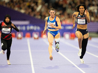 Karisma Tiarani of Indonesia, Martina Caironi of Italy, and Okoh Ndidikama of the UK compete in the Women's 100m - T63 Final at Stade de Fra...