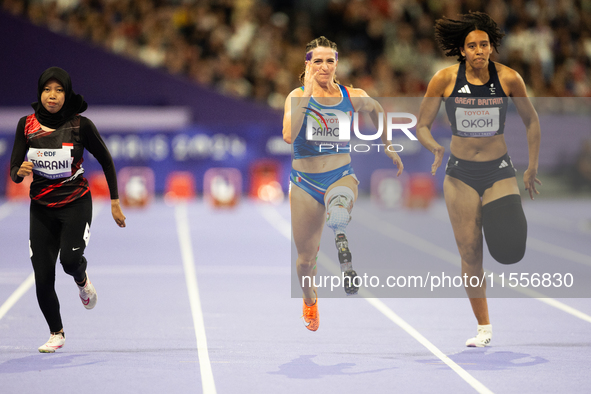 Karisma Tiarani of Indonesia, Martina Caironi of Italy, and Okoh Ndidikama of the UK compete in the Women's 100m - T63 Final at Stade de Fra...