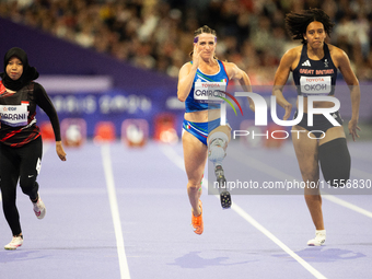 Karisma Tiarani of Indonesia, Martina Caironi of Italy, and Okoh Ndidikama of the UK compete in the Women's 100m - T63 Final at Stade de Fra...