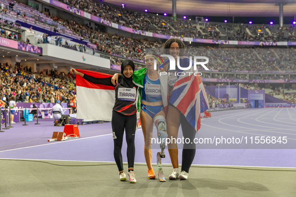 Karisma Tiarani of Indonesia, Martina Caironi of Italy, and Okoh Ndidikama of the UK react after the Women's 100m - T63 Final at Stade de Fr...