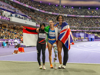 Karisma Tiarani of Indonesia, Martina Caironi of Italy, and Okoh Ndidikama of the UK react after the Women's 100m - T63 Final at Stade de Fr...