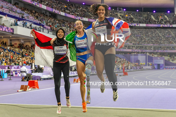 Karisma Tiarani of Indonesia, Martina Caironi of Italy, and Okoh Ndidikama of the UK react after the Women's 100m - T63 Final at Stade de Fr...