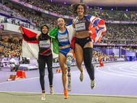 Karisma Tiarani of Indonesia, Martina Caironi of Italy, and Okoh Ndidikama of the UK react after the Women's 100m - T63 Final at Stade de Fr...