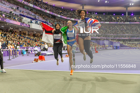 Karisma Tiarani of Indonesia, Martina Caironi of Italy, and Okoh Ndidikama of the UK react after the Women's 100m - T63 Final at Stade de Fr...