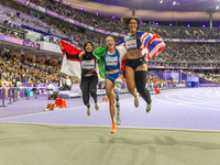 Karisma Tiarani of Indonesia, Martina Caironi of Italy, and Okoh Ndidikama of the UK react after the Women's 100m - T63 Final at Stade de Fr...