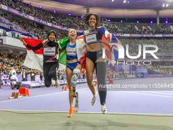 Karisma Tiarani of Indonesia, Martina Caironi of Italy, and Okoh Ndidikama of the UK react after the Women's 100m - T63 Final at Stade de Fr...