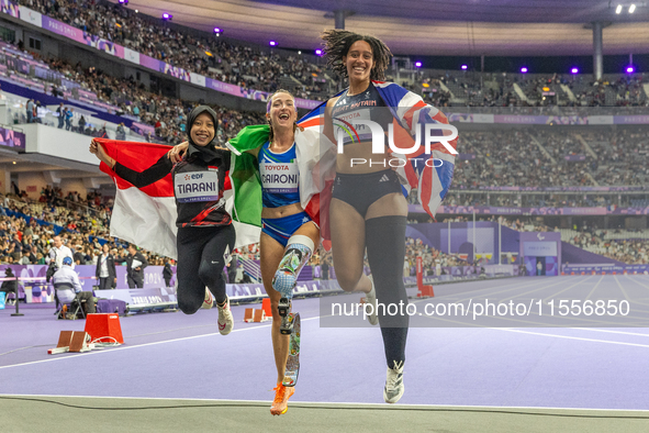 Karisma Tiarani of Indonesia, Martina Caironi of Italy, and Okoh Ndidikama of the UK react after the Women's 100m - T63 Final at Stade de Fr...