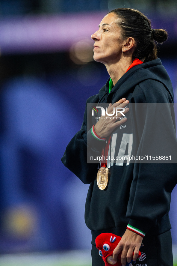 Monica Contrafatto of Italy stands on the podium after she wins the bronze medal in the Women's 100m - T63 Final at Stade de France during t...