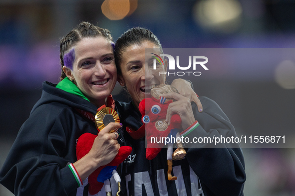 Martina Caironi of Italy and Monica Contrafatto react on the podium of Women's 100m - T63 Final at Stade de France during the Paris 2024 Par...