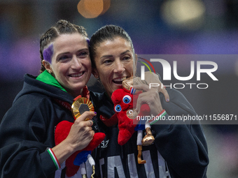 Martina Caironi of Italy and Monica Contrafatto react on the podium of Women's 100m - T63 Final at Stade de France during the Paris 2024 Par...