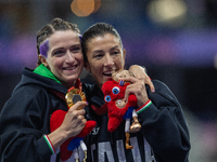 Martina Caironi of Italy and Monica Contrafatto react on the podium of Women's 100m - T63 Final at Stade de France during the Paris 2024 Par...